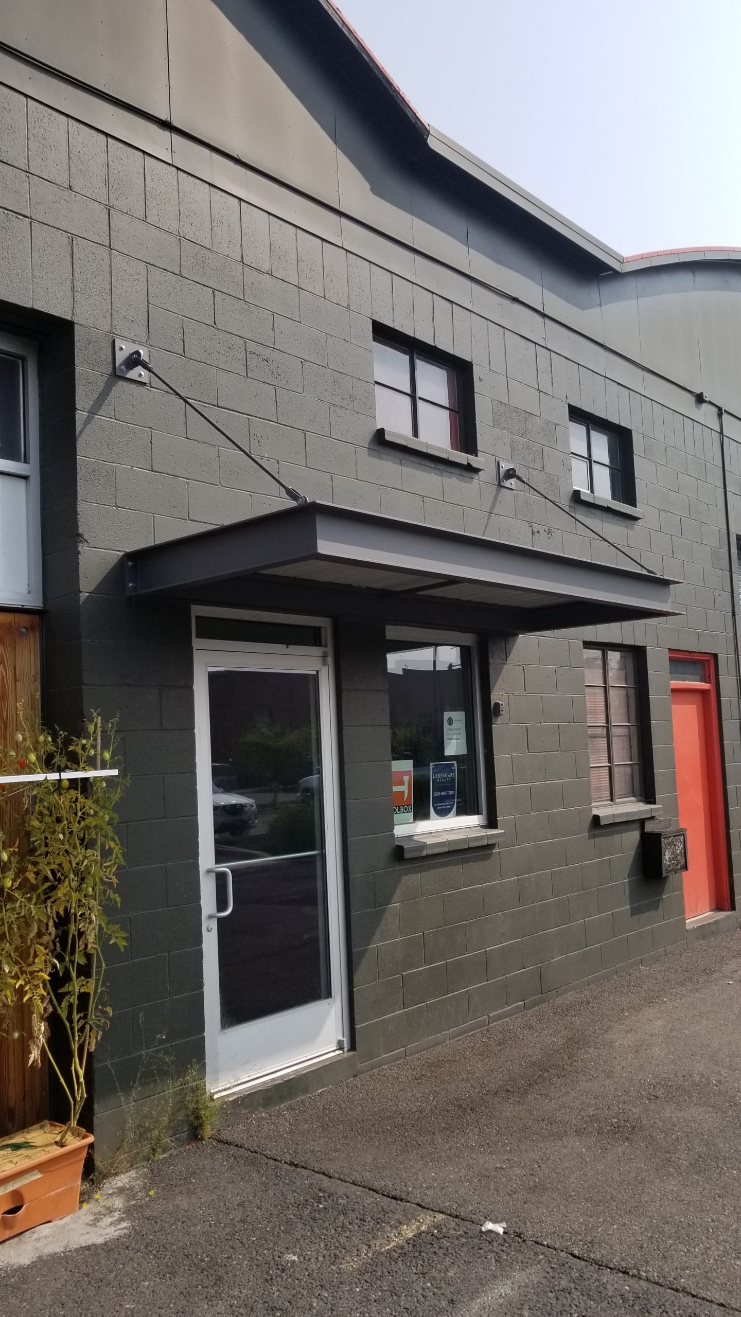 architectural canopy attached to green brick wall