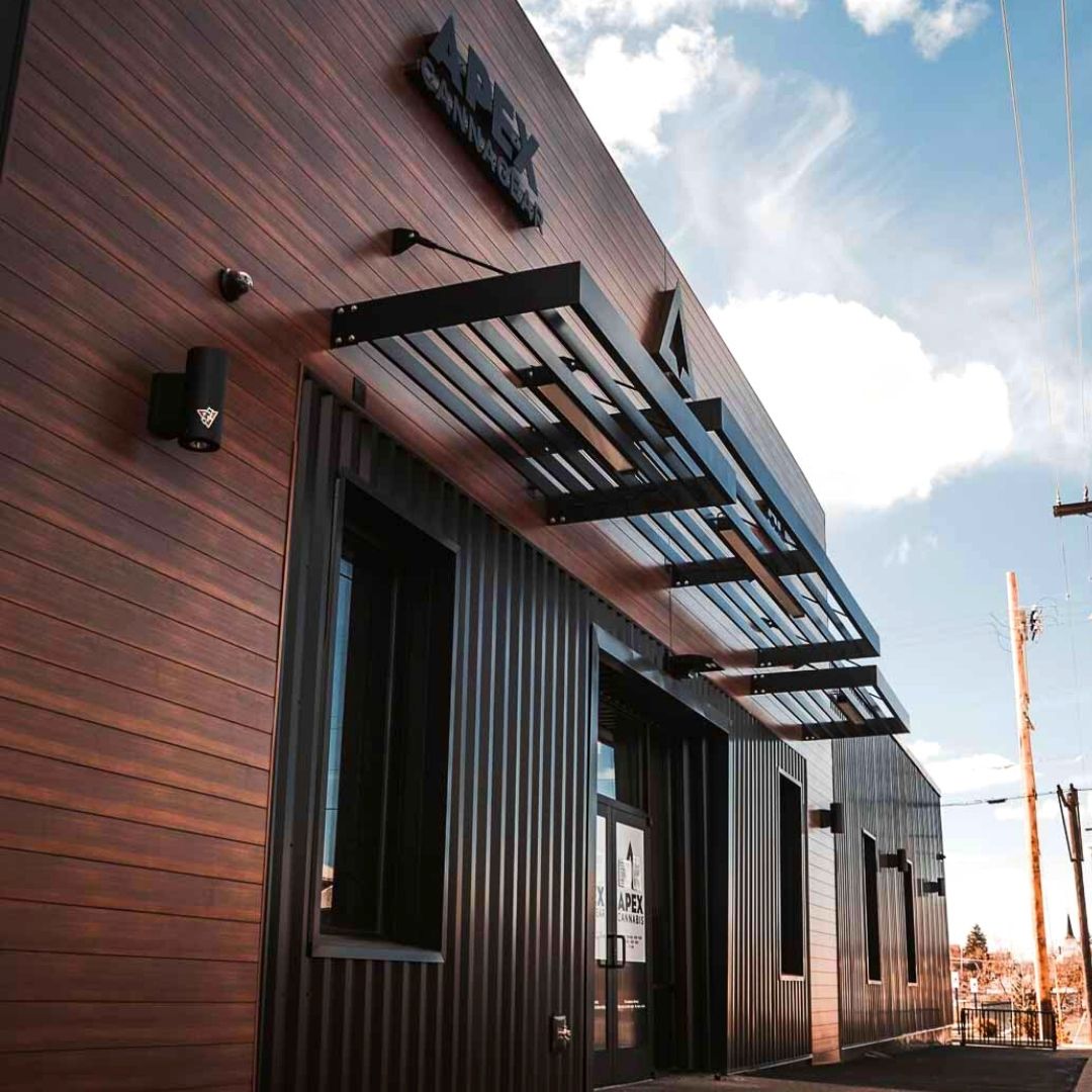 APEX Commercial Louvered Architectural Sunshade System The image shows a side perspective of Vestis louvered sunshades mounted above the entrance of the APEX Cannagear flagship retail building.