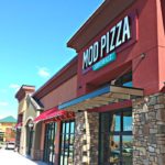 MOD Pizza restaurant storefront with louvered sunshades