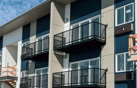 bolt-on balconies attached to a multi-family apartment with multiple stories.