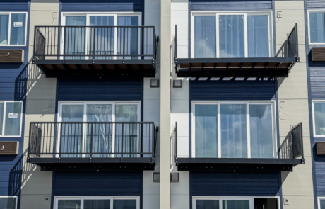 Aluminum bolt-on balcony attached to cottage style apartments with one balcony finished