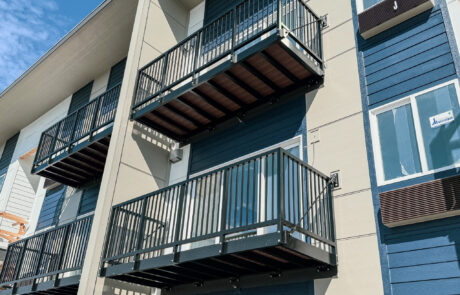 Multiple Aluminum Bolt-On Balconies attached to a multifamily apartment building in a coastal area