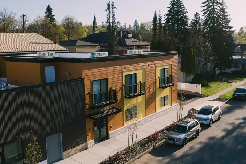 Indiana Apartments Architectural Balcony System The image shows a modern two-story apartment building with Vestis architectural balcony systems installed along the upper level, overlooking a residential street.