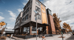 The image shows a multi-family residential building with Vestis architectural canopies and sunshades integrated into the façade.