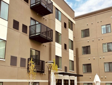 multiple black bolt-on balconies attached to a multistory hotel