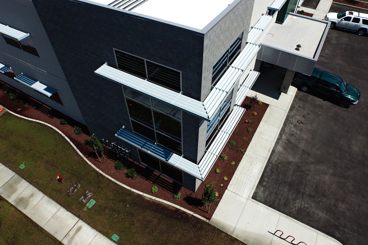 commercial concrete tilt up building with aluminum louvered sunshades attached