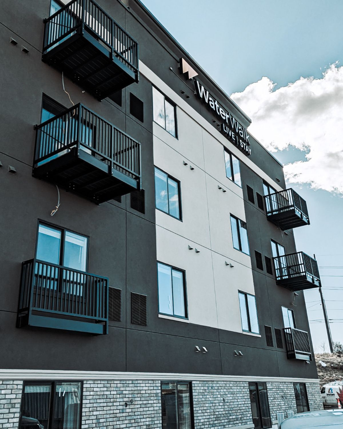 multi-family hotel with a blue sky and bolt on balconies